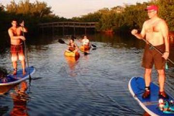 a man riding on the back of a boat in the water